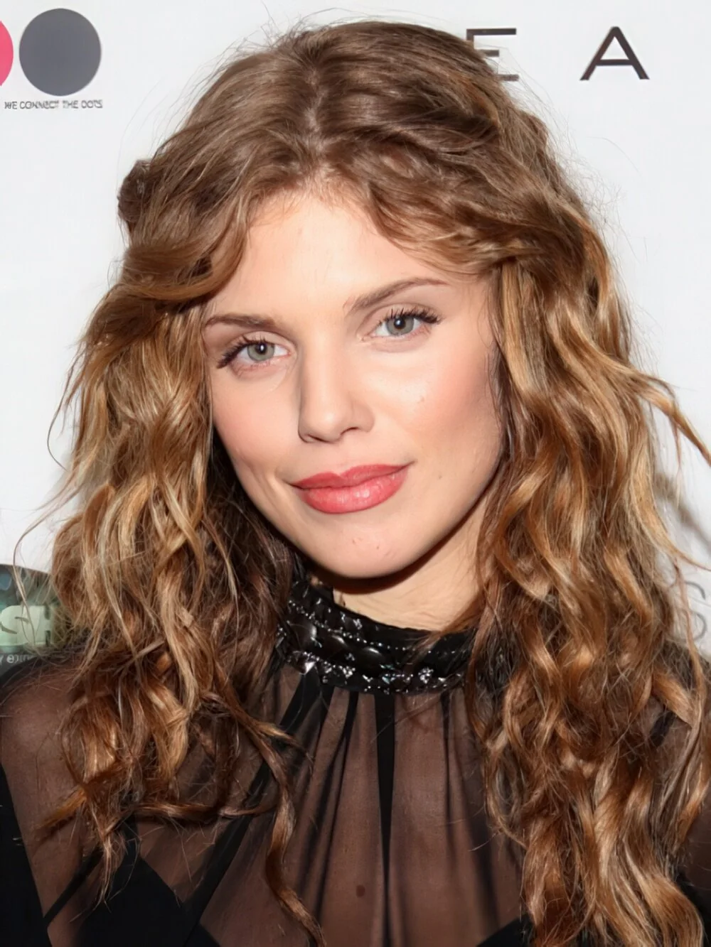 Long brunette curls with a center part.