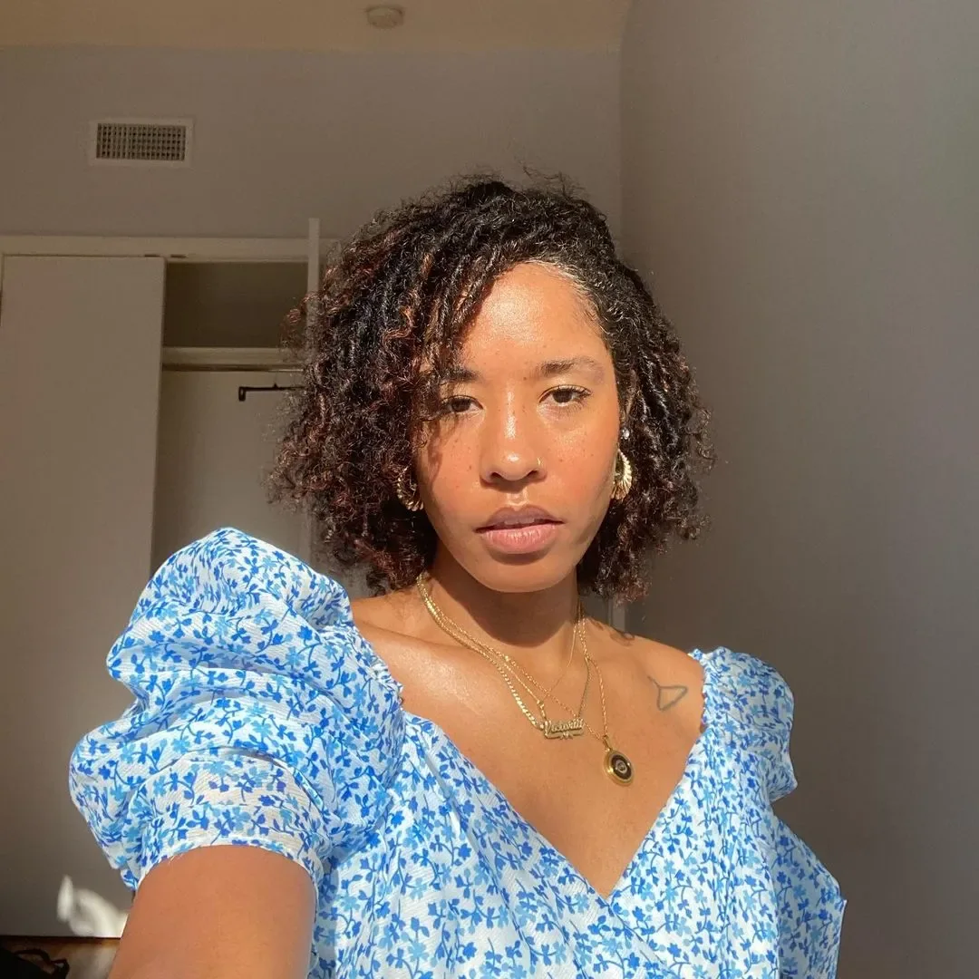 Photo showing side Parted Natural Curly Bob, with the hairstyle clearly visible.