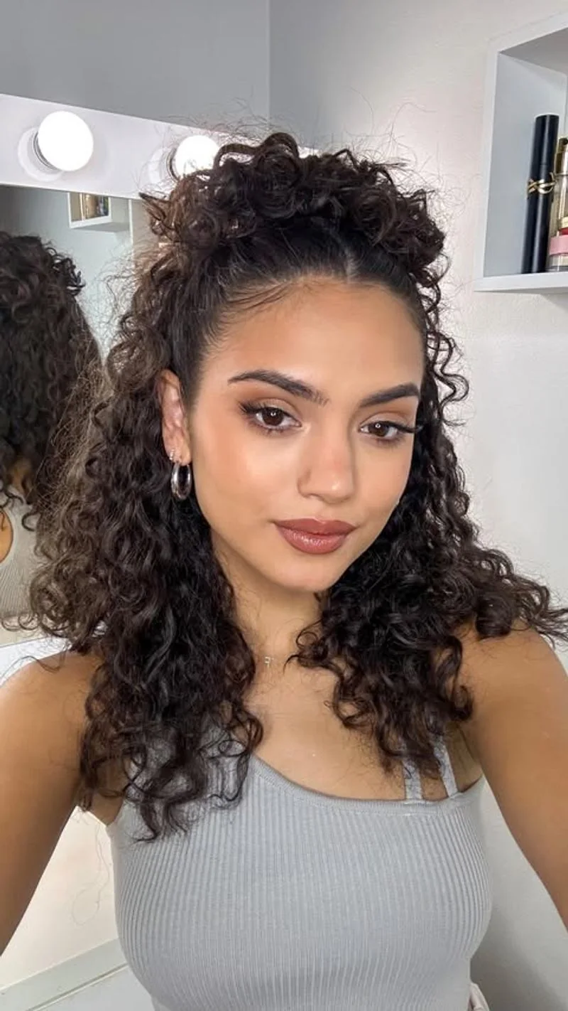 Long Curls in a High half-up Style.