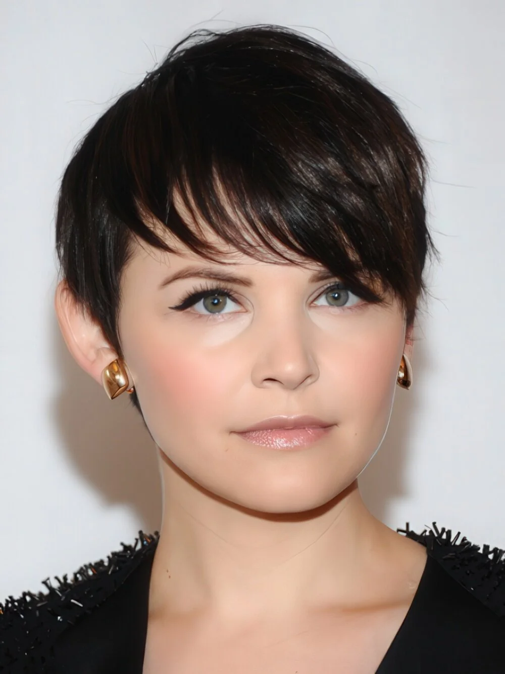 Short black pixie with side-swept bangs.