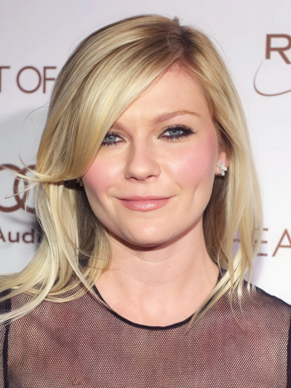 Long blonde layers with side-swept bangs.