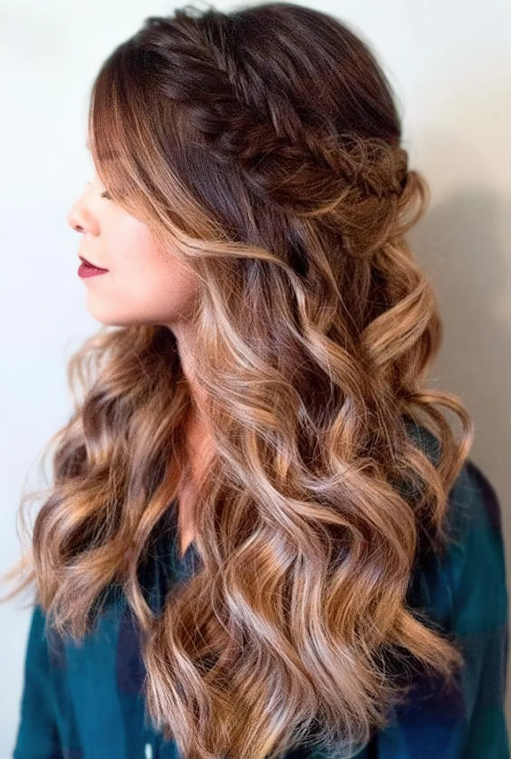 Half updo with a fishtail braided halo and waves down, with a sligth ombre effect for a party.