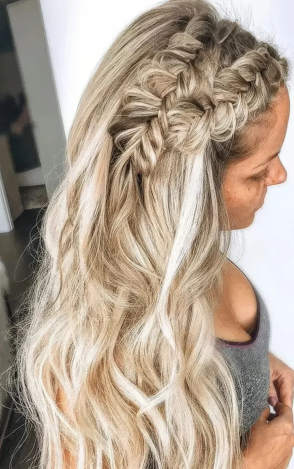 Boho wedding half updo with a double braid on top and waves down.