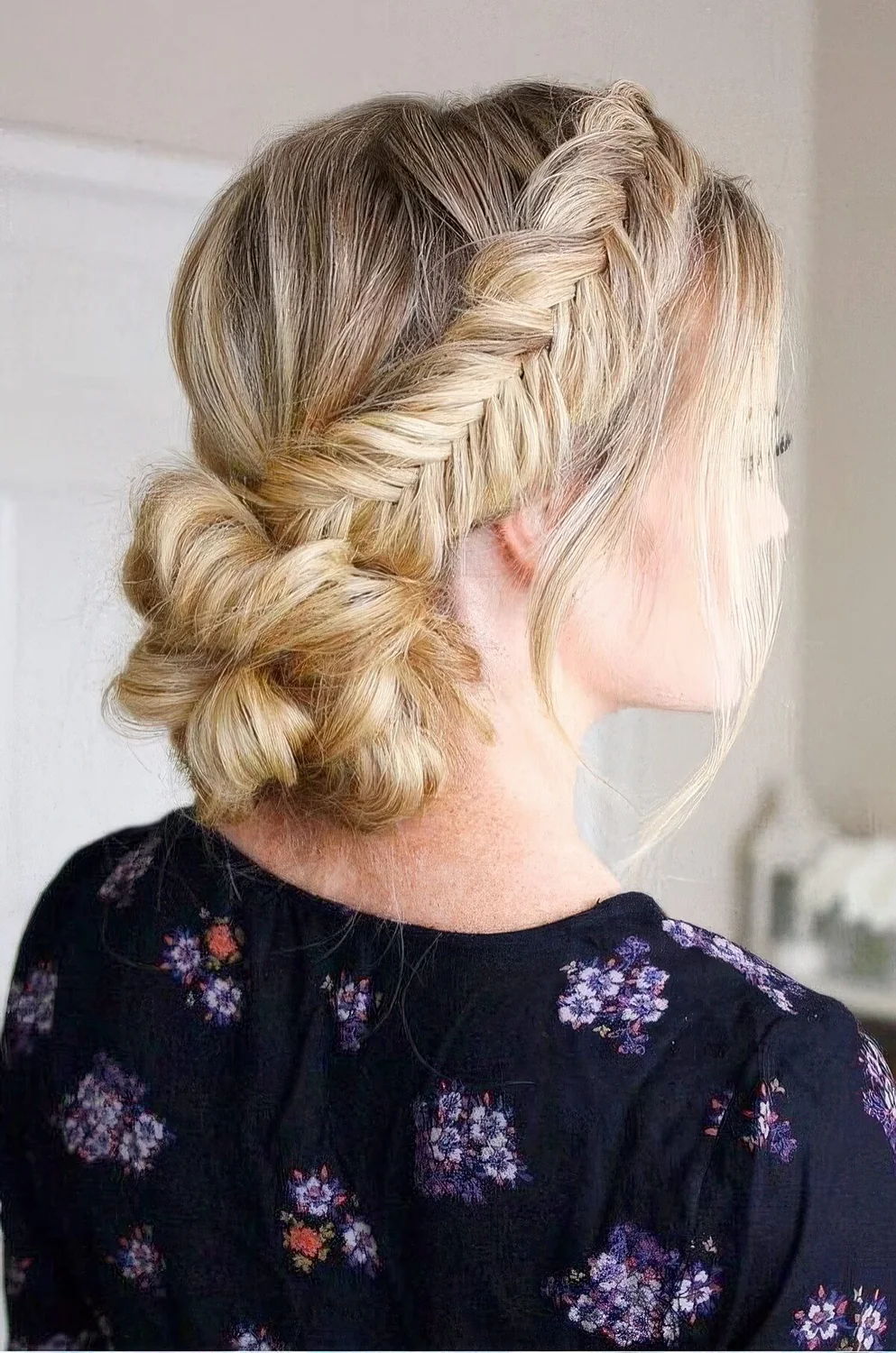 Low bun with two fishtail side braids and a bump.