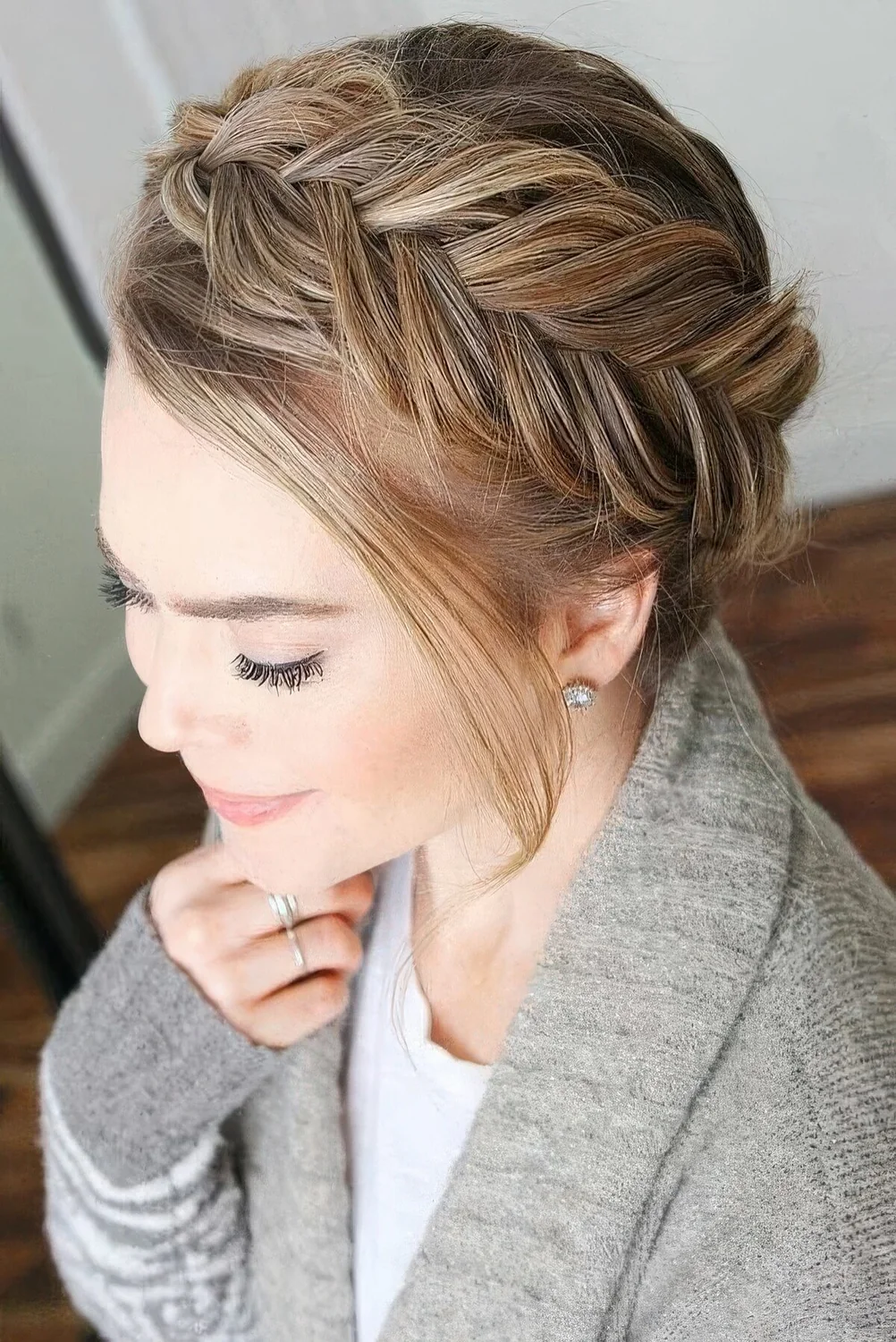 Loose fishtail braid updo with some face-framing hair.