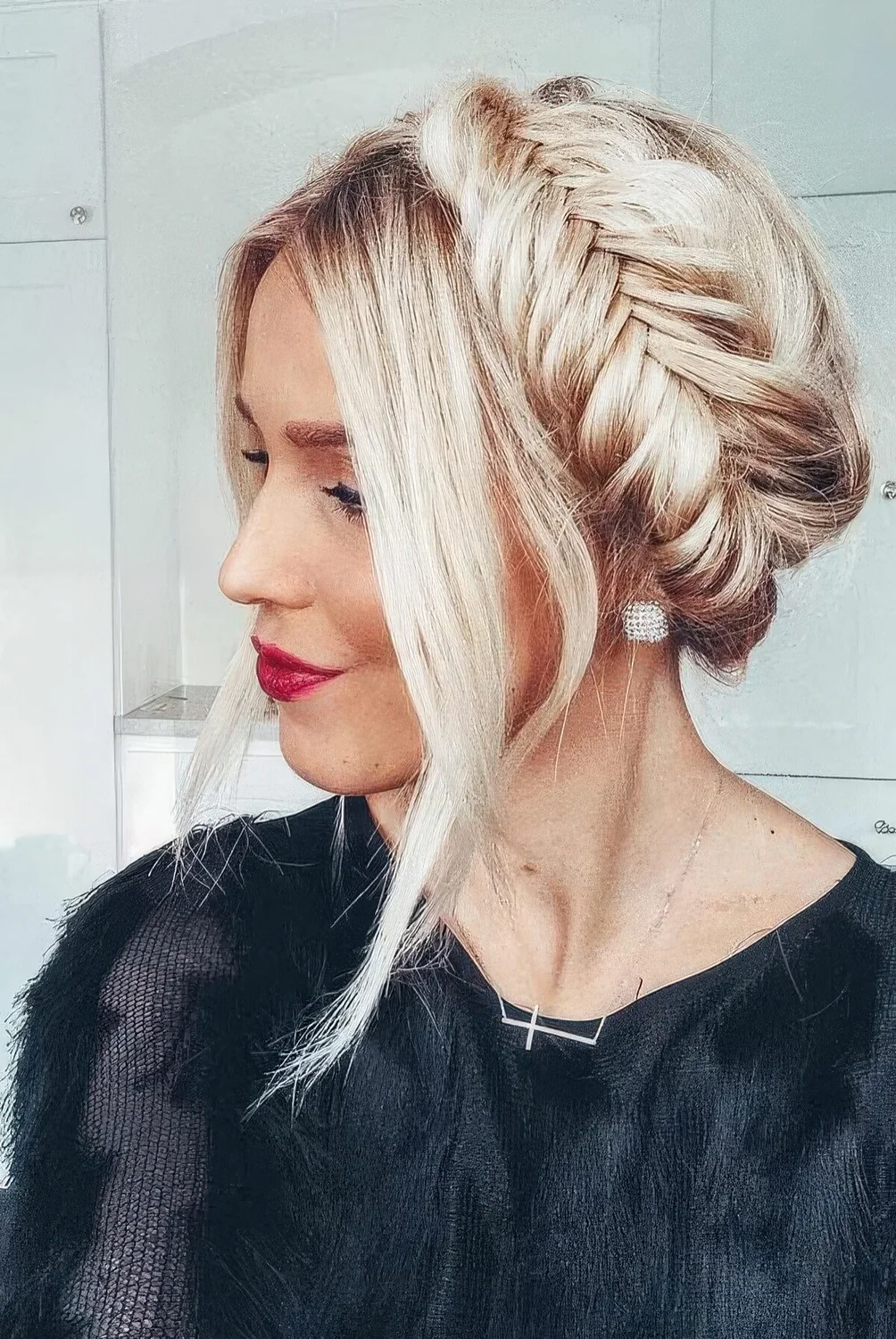 Updo with a pretty fishtail braid halo and face-framing locks.