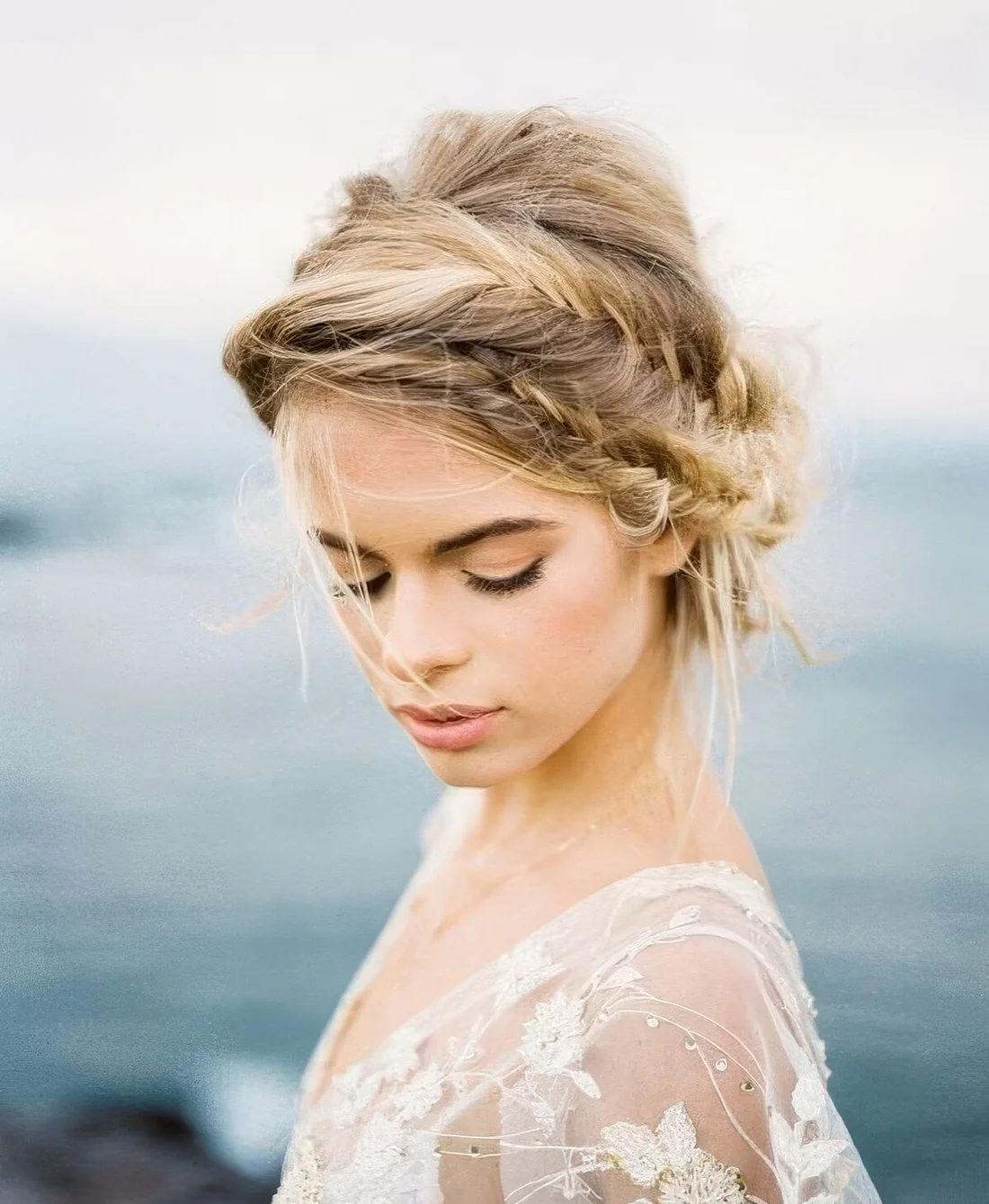 Messy low updo with a double fishtail braid and some hair down.