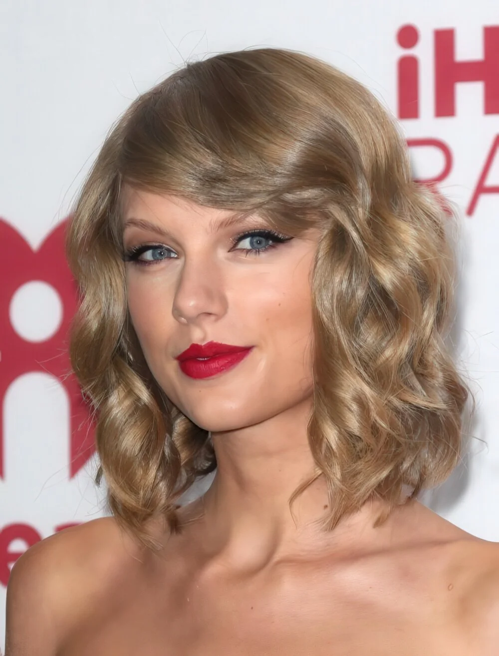 Blonde wavy bob with side-swept bangs.