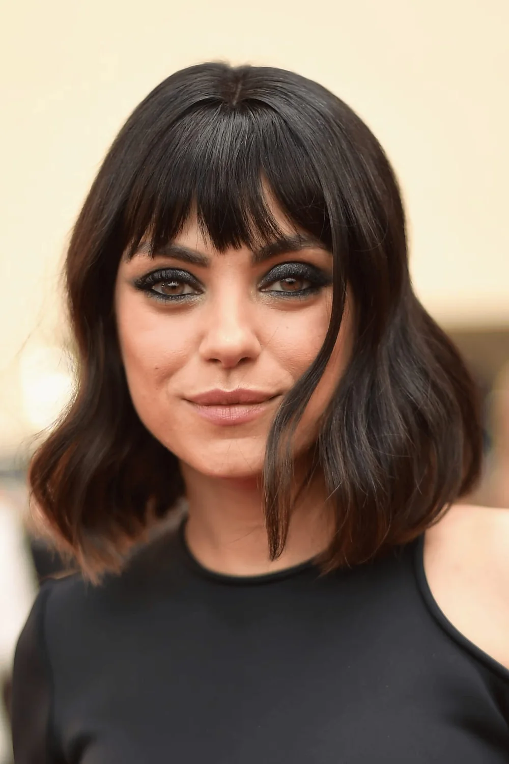 Photo showing sleek Bob With Piecey Blunt Bangs, with the hairstyle clearly visible.