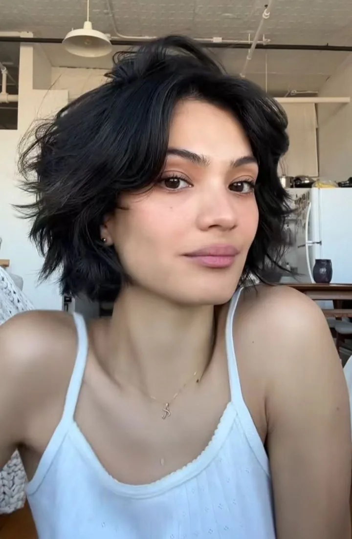 Photo showing tousled Shag With Curtain Fringe, with the hairstyle clearly visible.