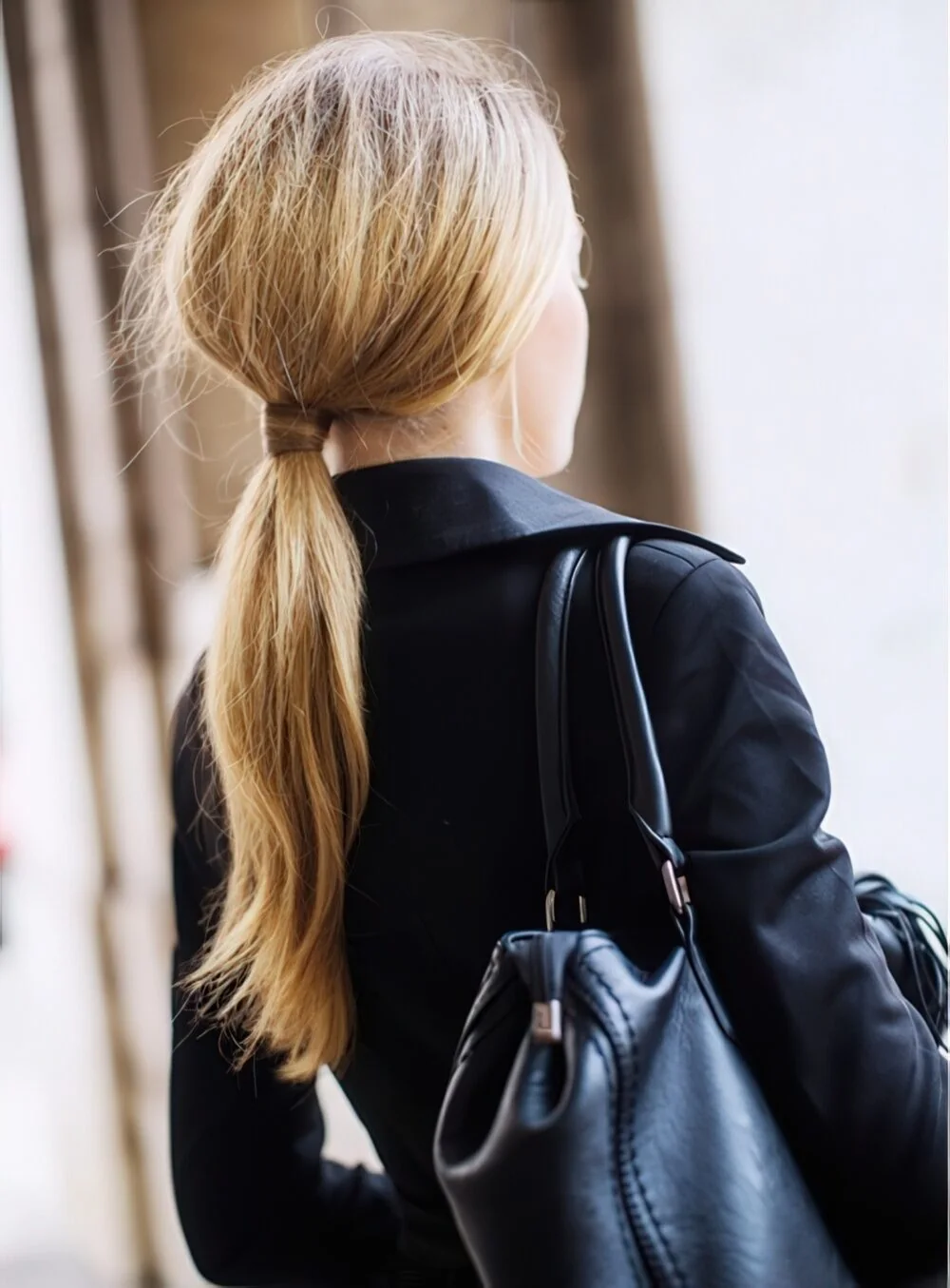 Photo showing simple low blonde ponytail, with the hairstyle clearly visible.