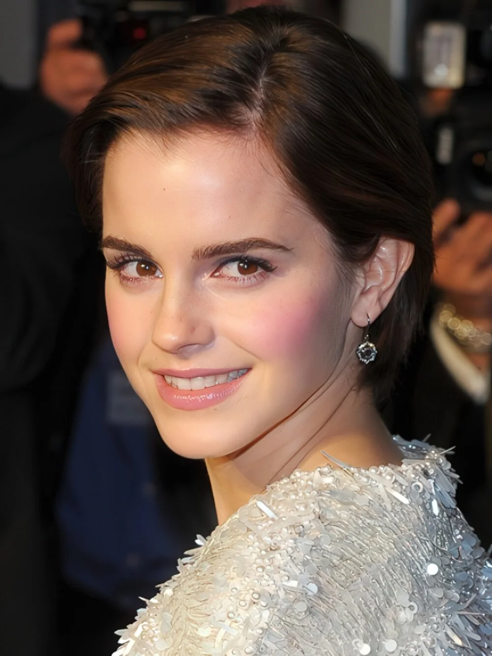 Sleek brunette pixie with a side part.