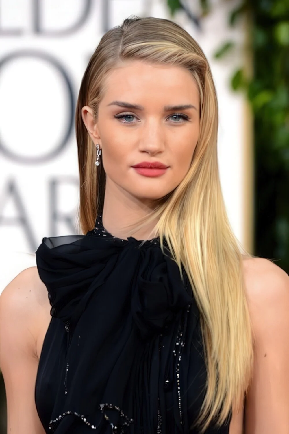 Long blonde hair with bangs pinned to the side.