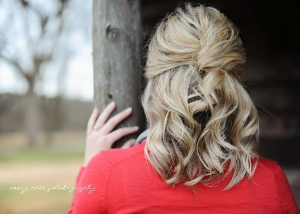 Twisted half-up ponytail with loose waves.