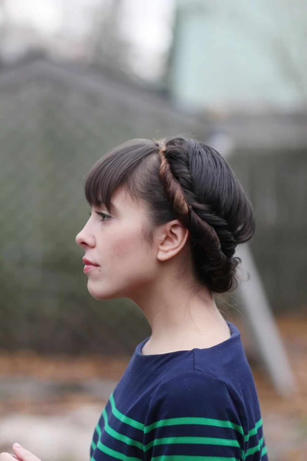 Twisted headband gathered into a low bun.