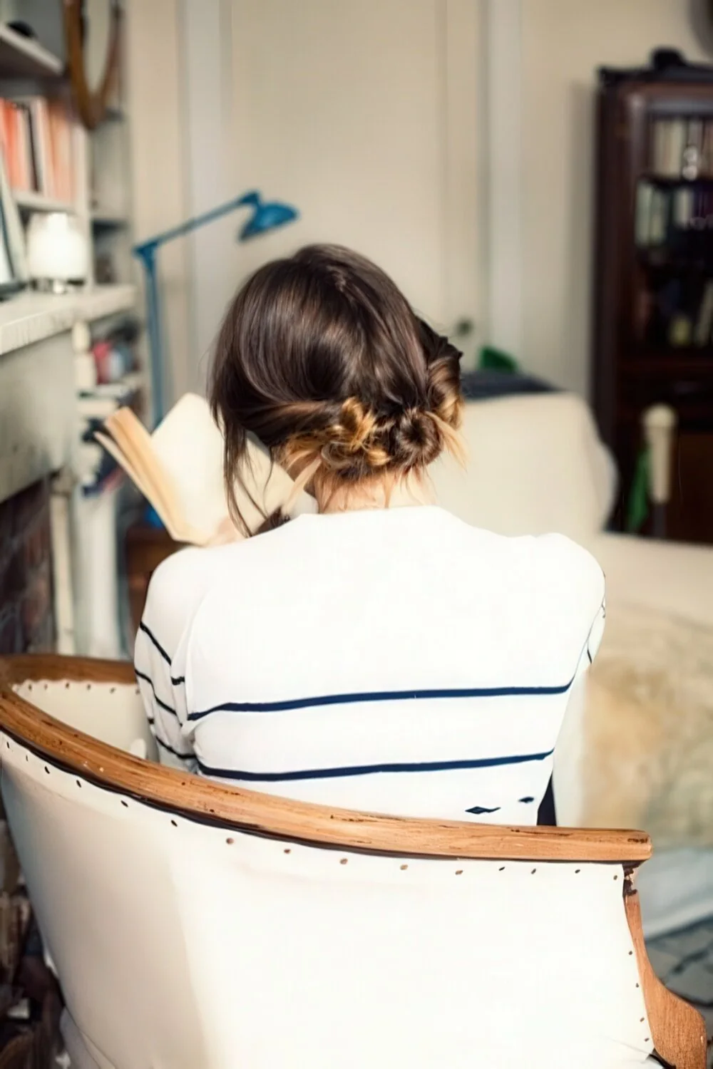 Photo showing loose twisted brunette low bun, with the hairstyle clearly visible.
