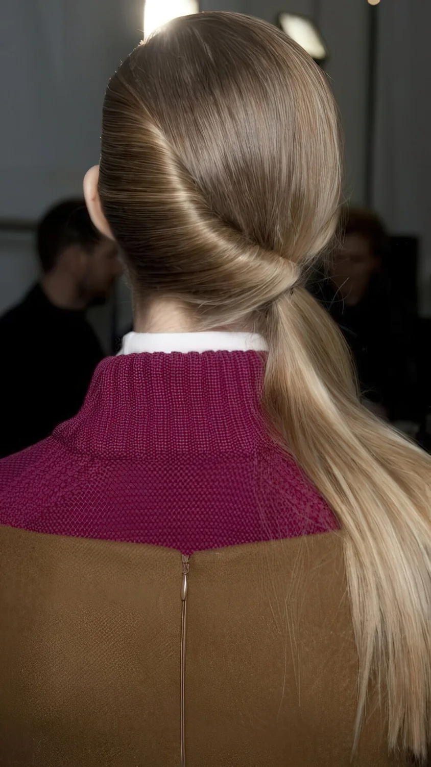 Photo showing sleek wrapped low ponytail, with the hairstyle clearly visible.