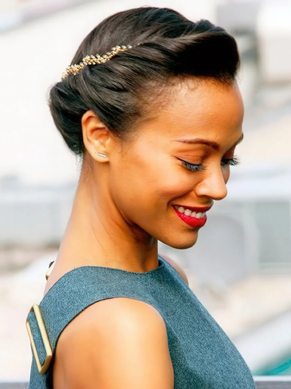 Polished dark French twist with a slim headband.