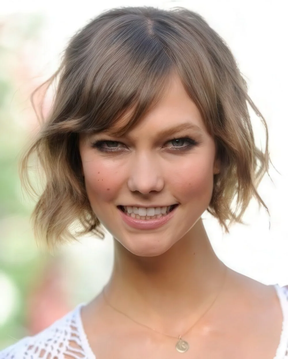 Wavy brunette chin-length bob with wispy bangs.