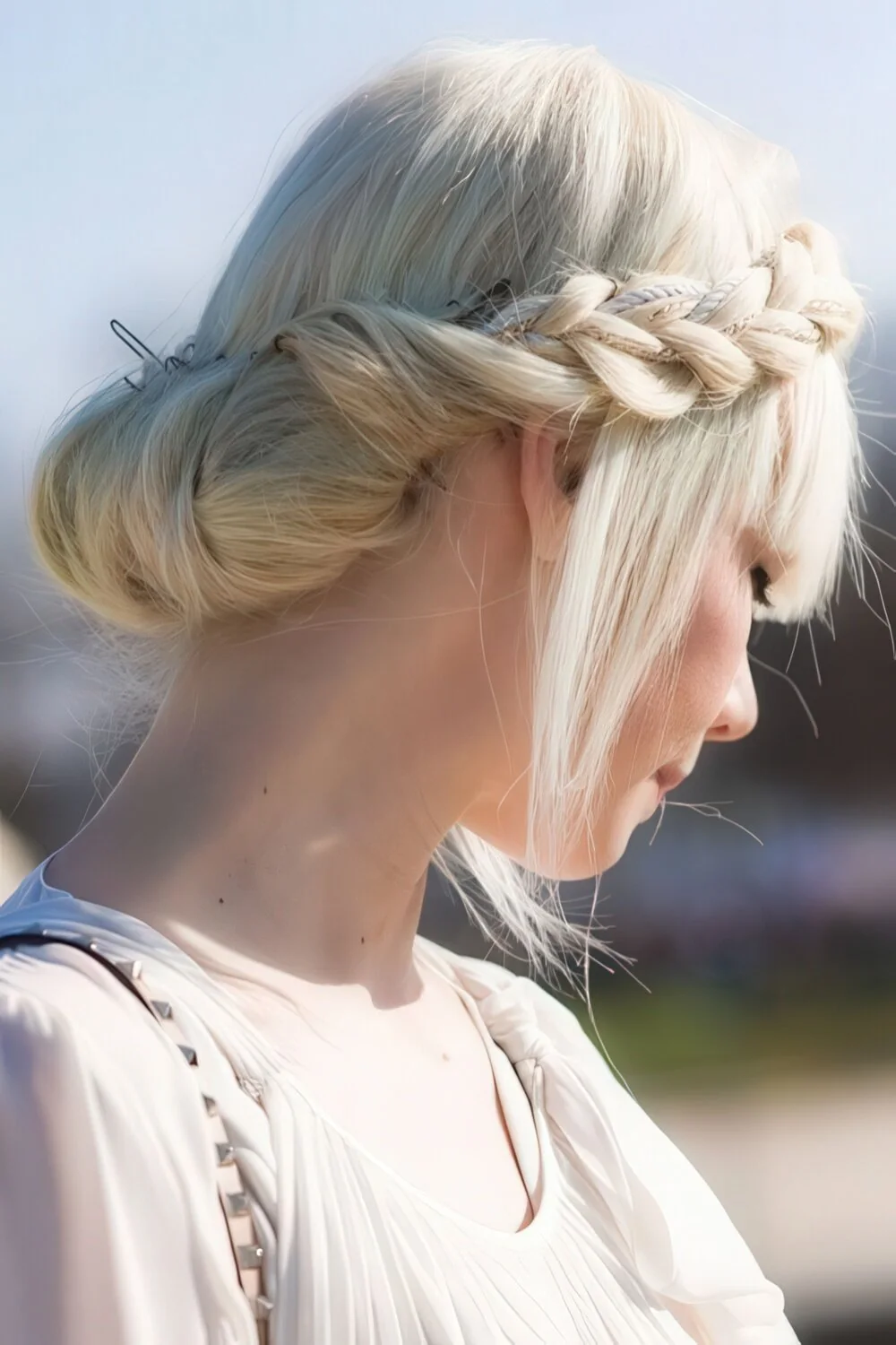 Side crown braid gathered into a low chignon.