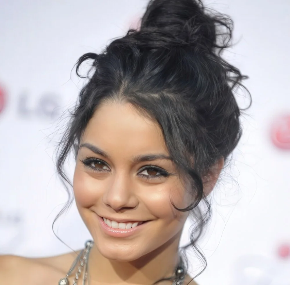 Messy high bun with loose face-framing pieces.