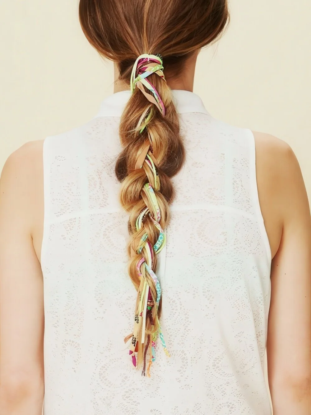 Photo showing ribbon-wrapped ponytail braid, with the hairstyle clearly visible.