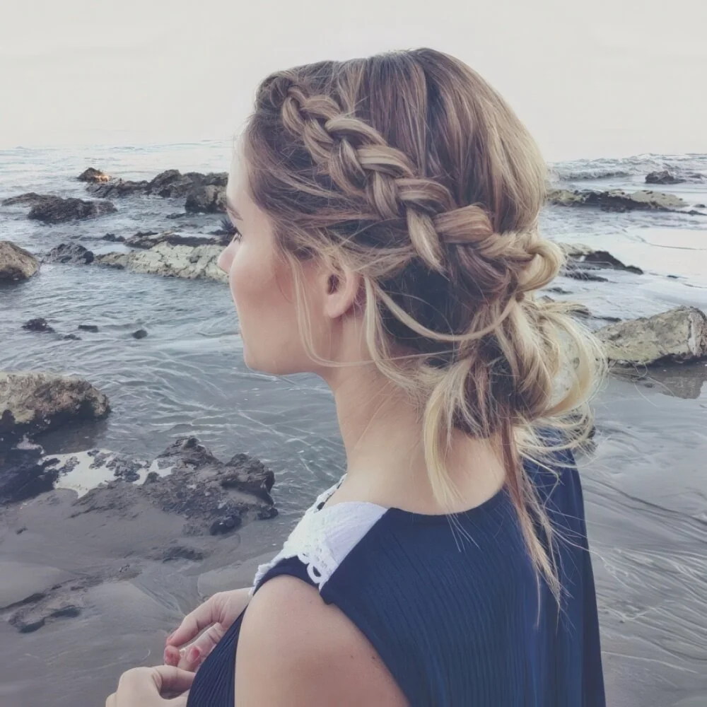 Photo showing braided messy low updo, with the hairstyle clearly visible.