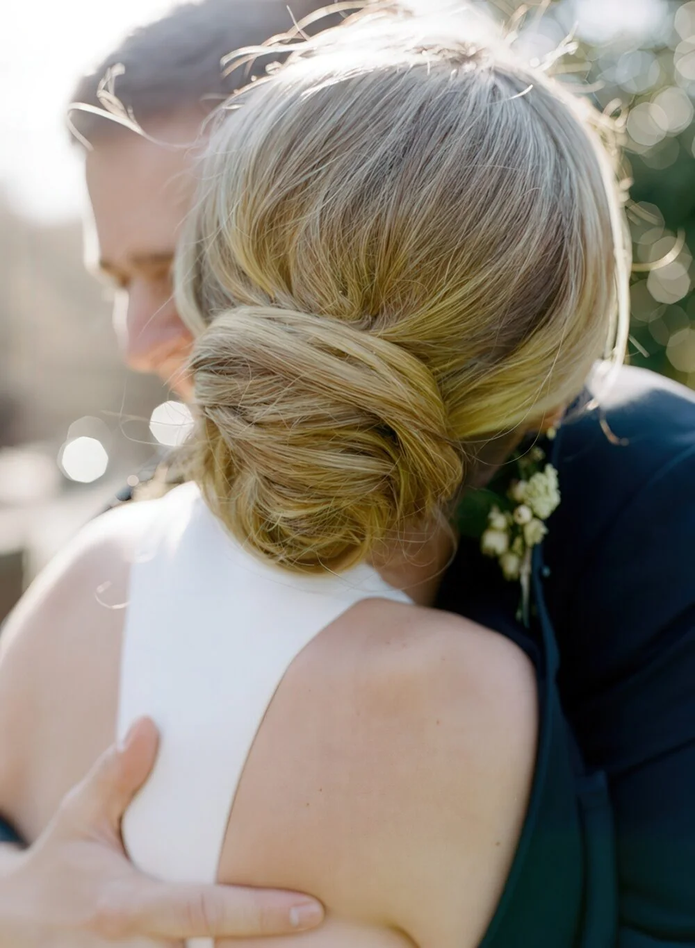 Soft blonde twisted wedding chignon.