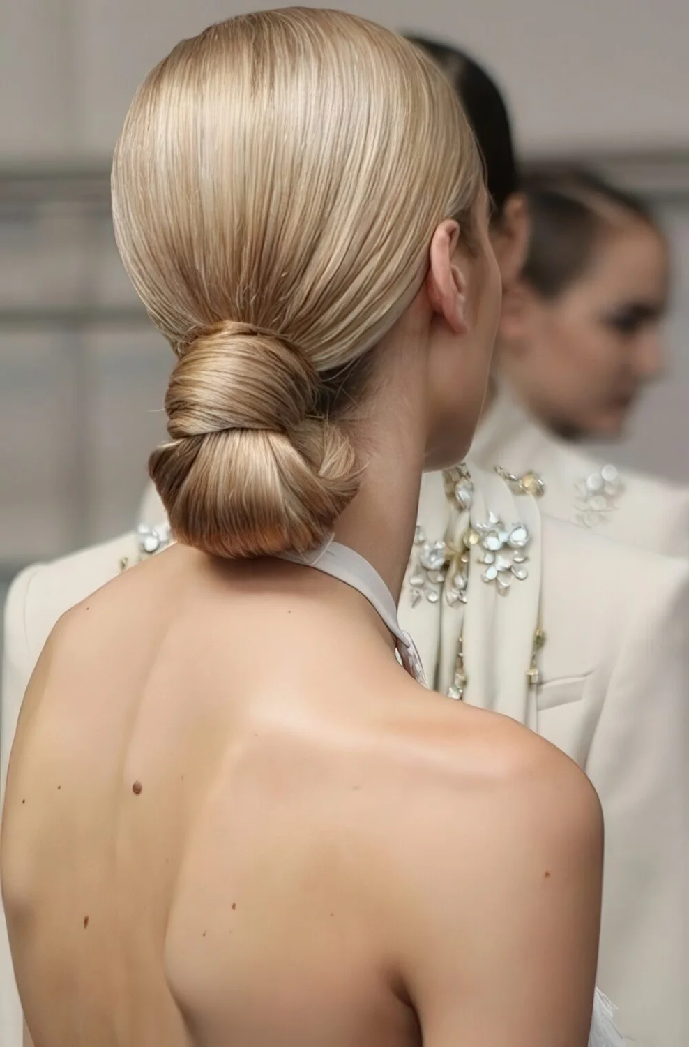 Smooth blonde wrapped low ponytail.