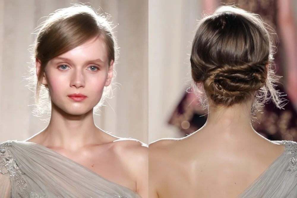 Braided low chignon with a smooth crown.
