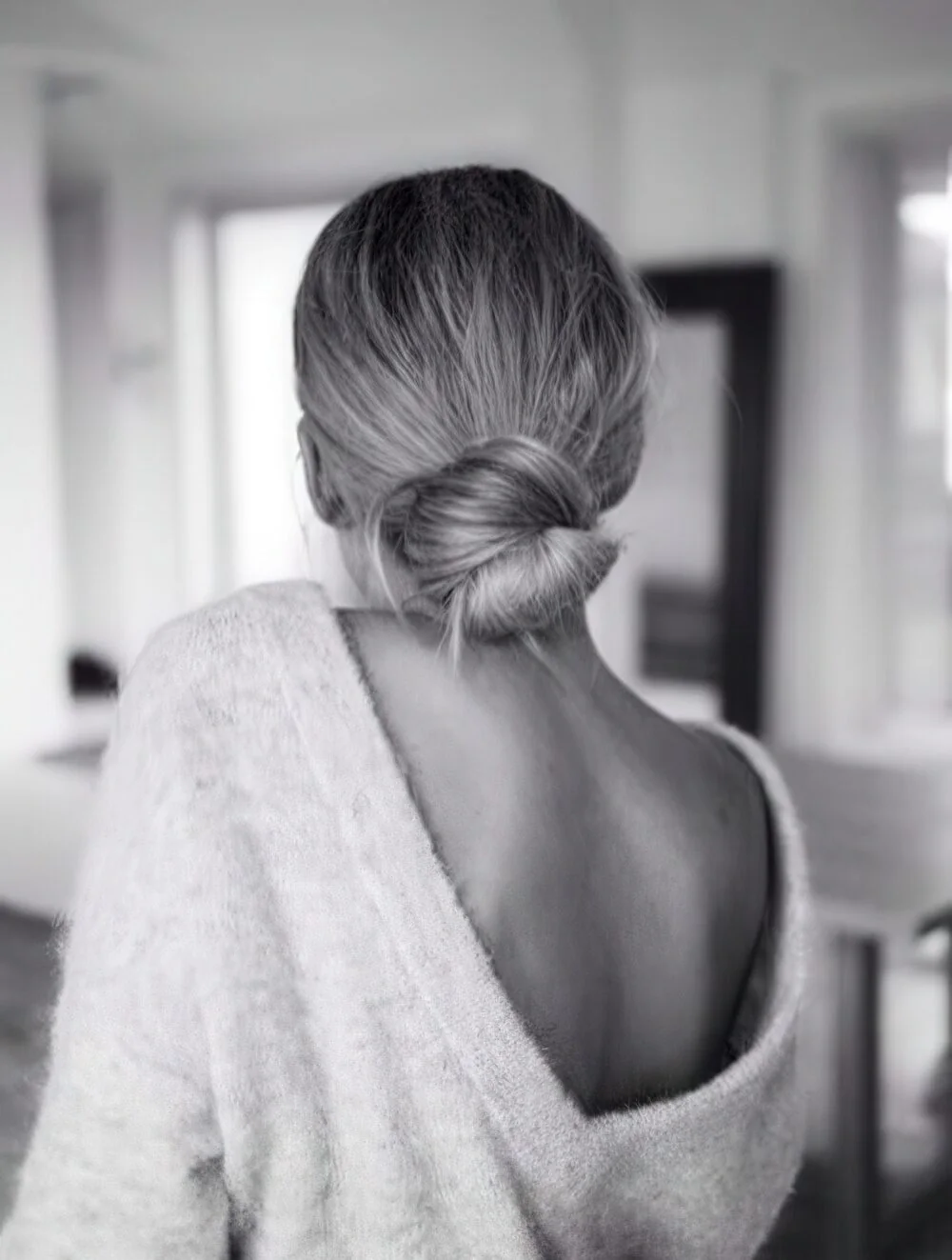 Photo showing relaxed silver low bun, with the hairstyle clearly visible.