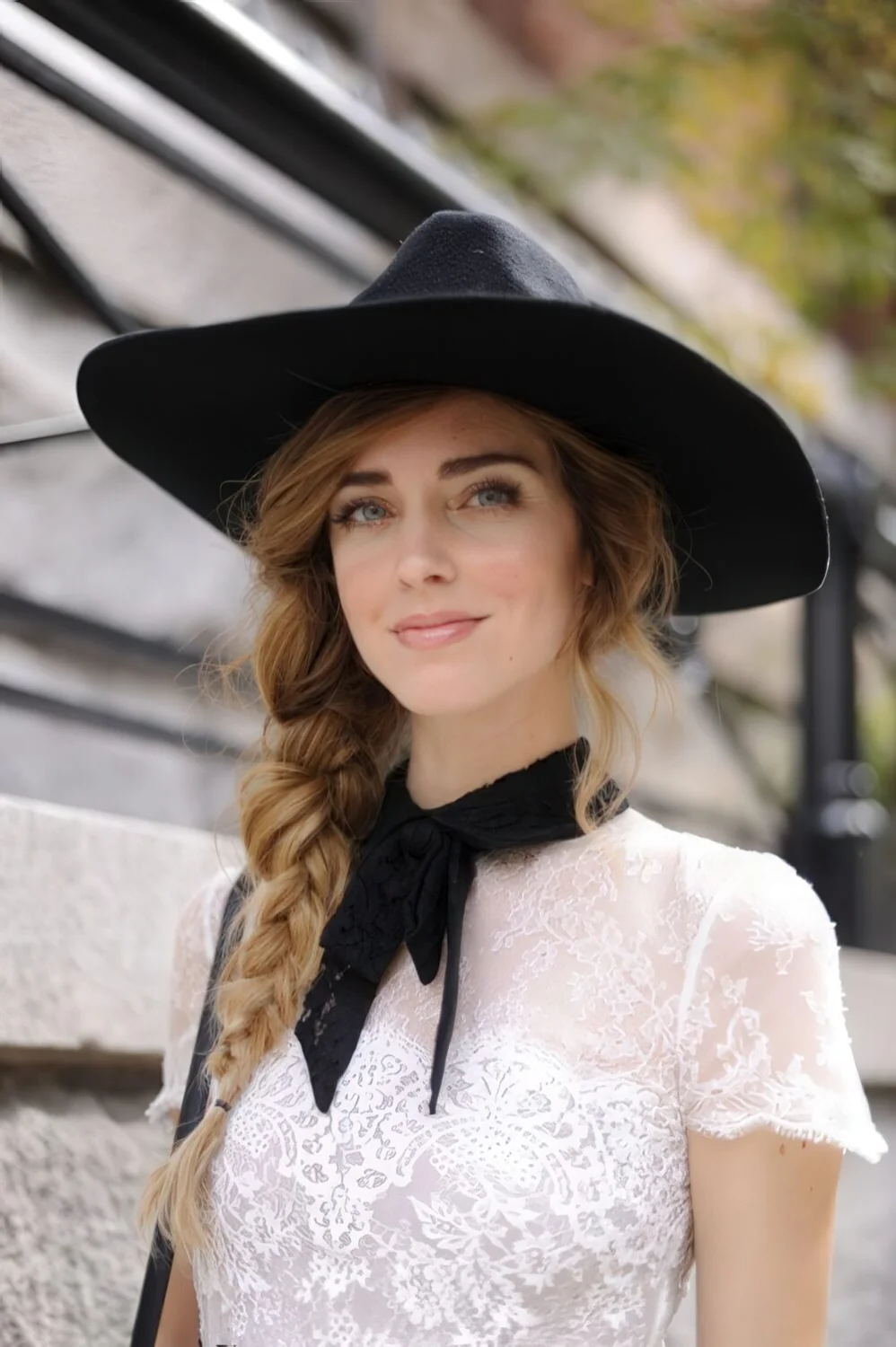 Thick brunette side braid under a wide-brim hat.