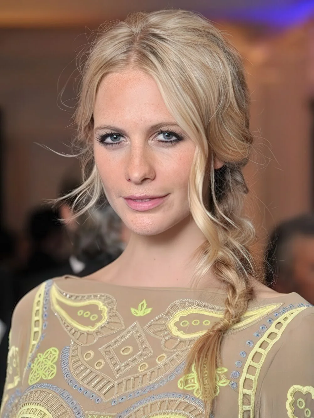 Soft blonde side braid with loose face-framing pieces.