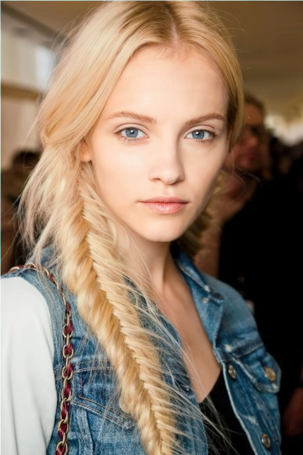 Photo showing long blonde fishtail side braid, with the hairstyle clearly visible.