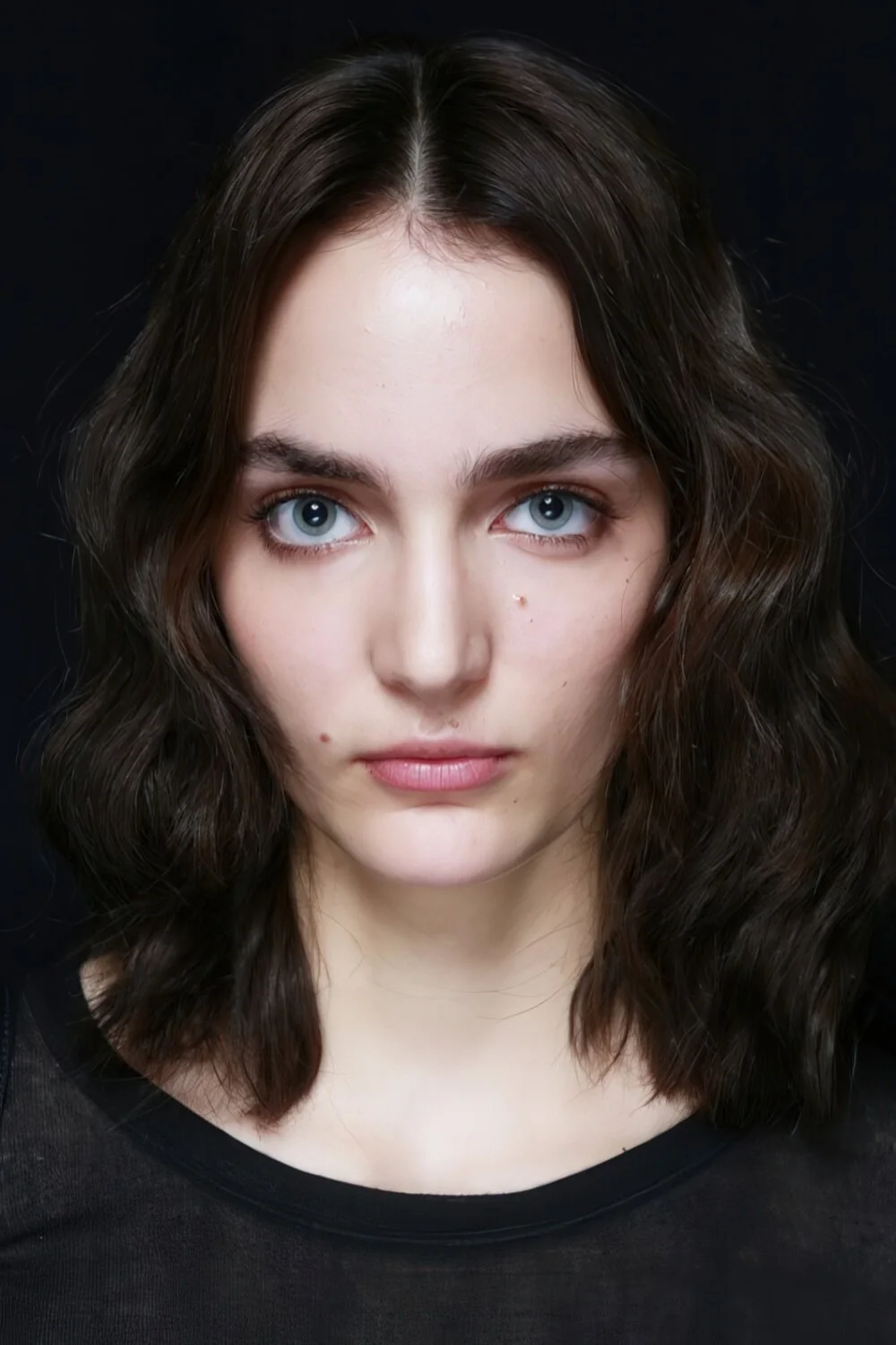 Shoulder-length brunette waves with a center part.