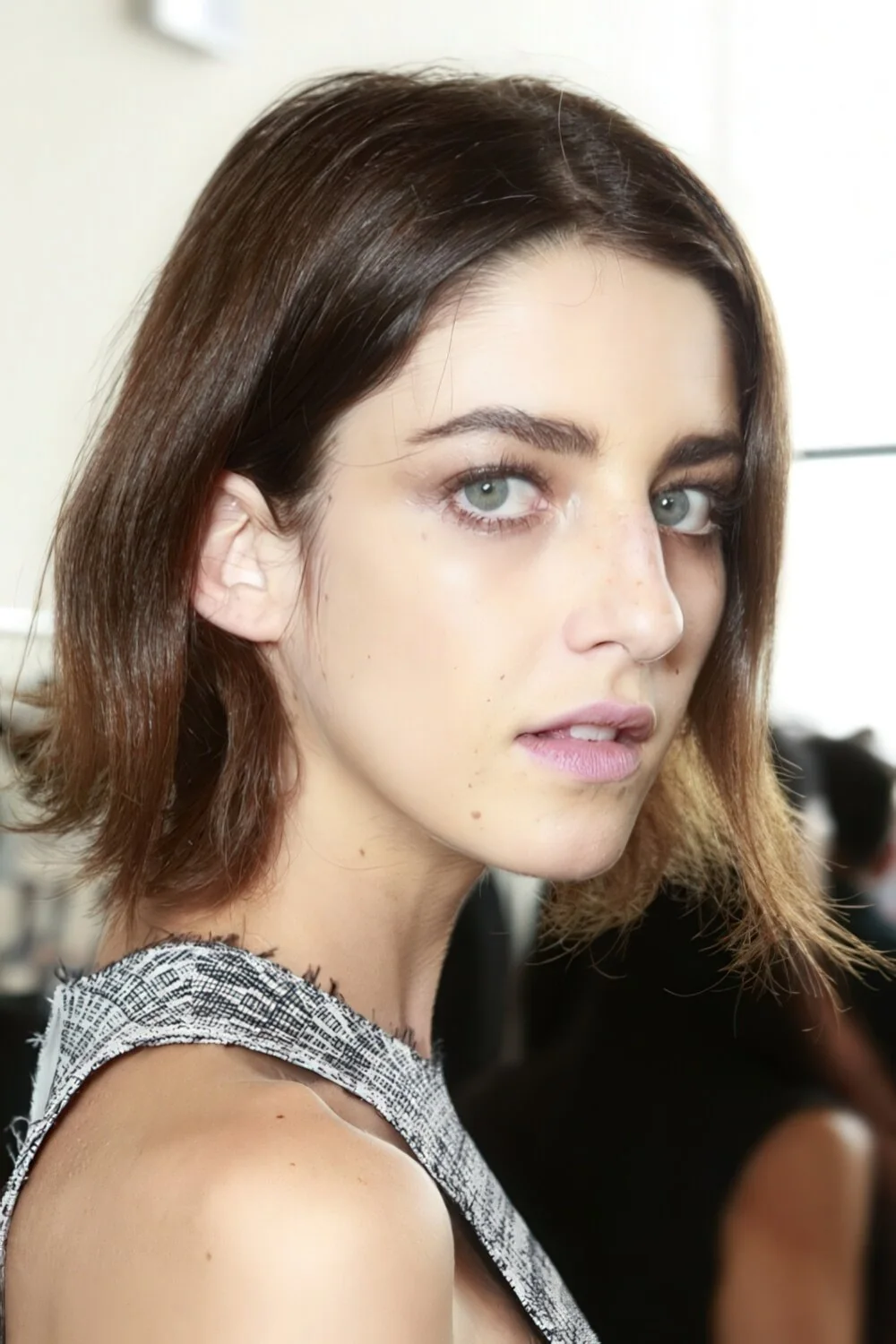 Flipped-out brunette bob with a side part.