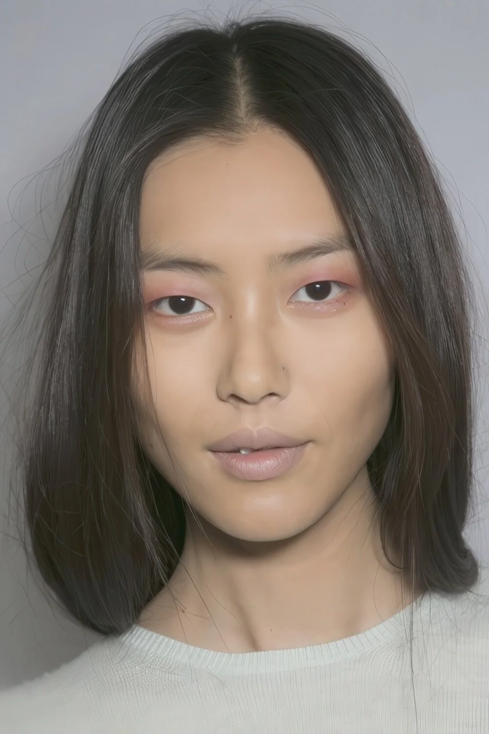 Blunt black bob with a center part.
