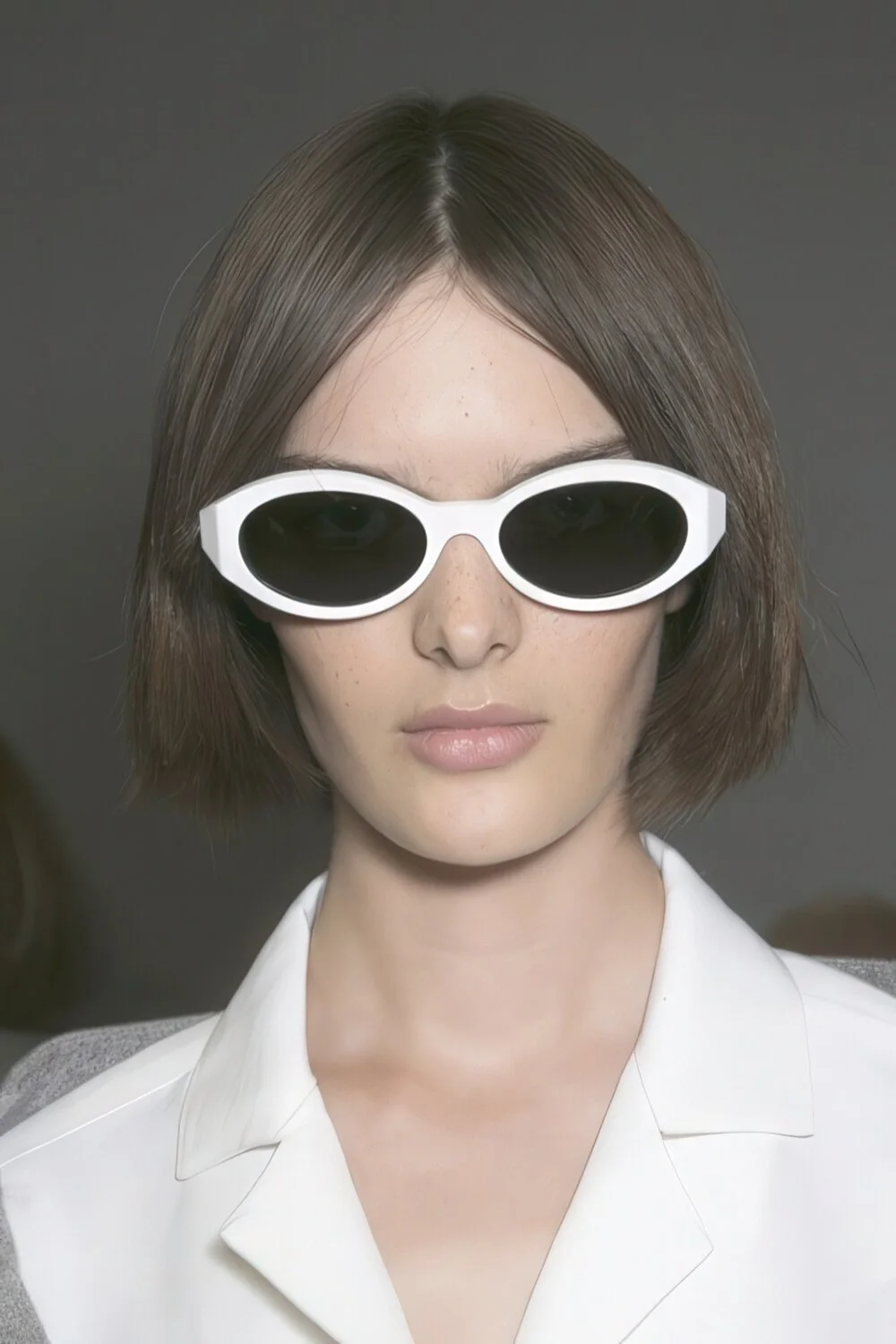 Blunt brunette bob with a center part.