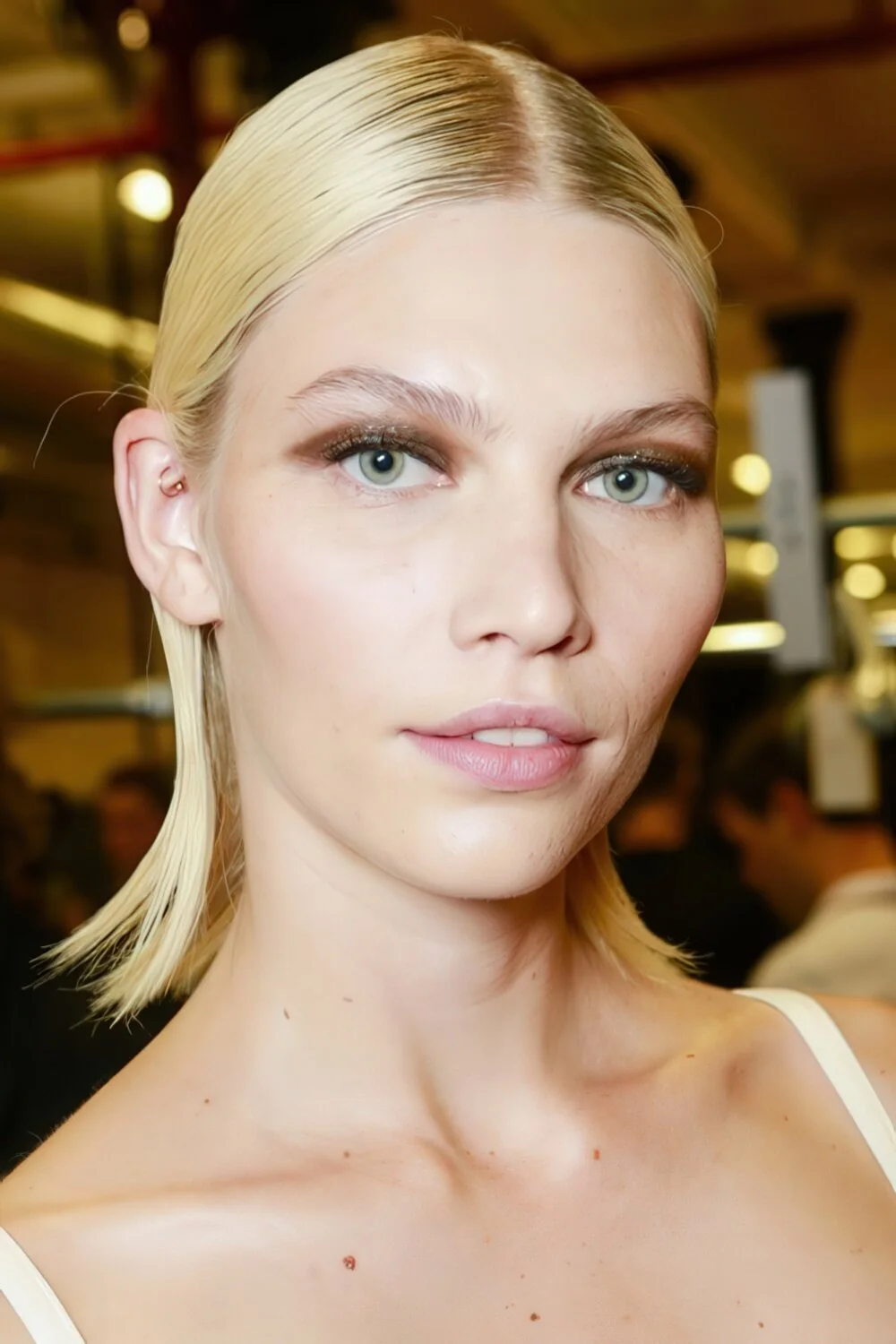 Slick blonde low ponytail with flipped ends.