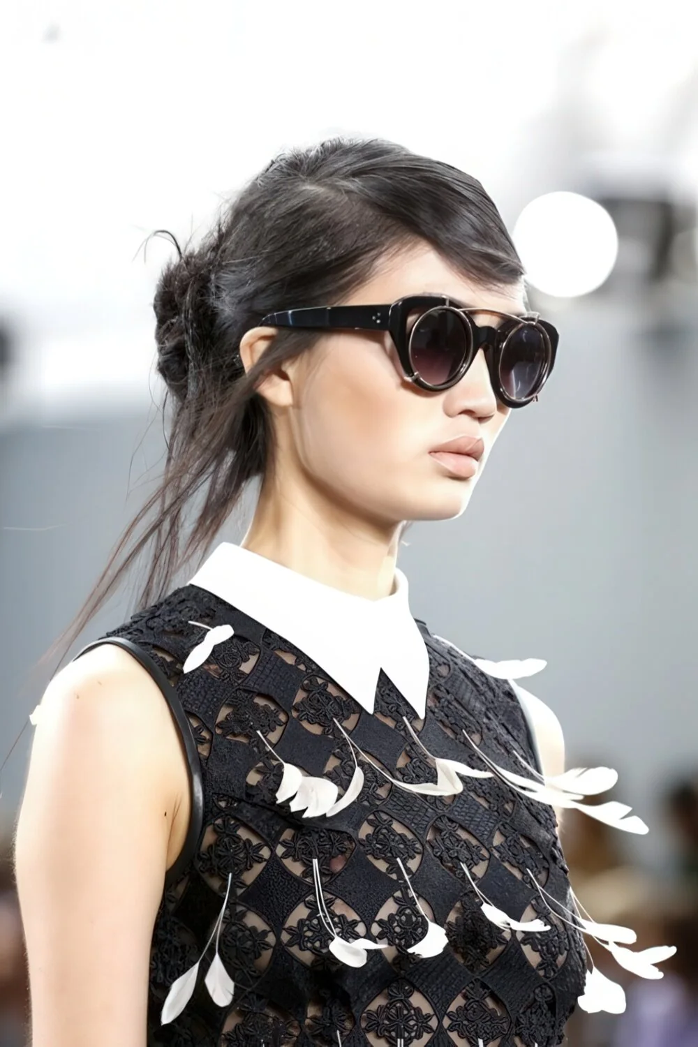 Tousled dark updo with loose front strands.