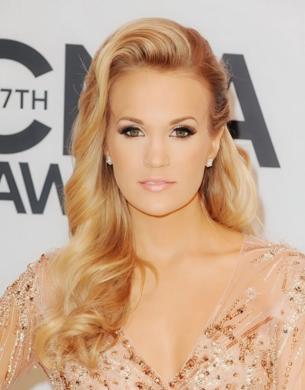 Long blonde curls with a deep side part.
