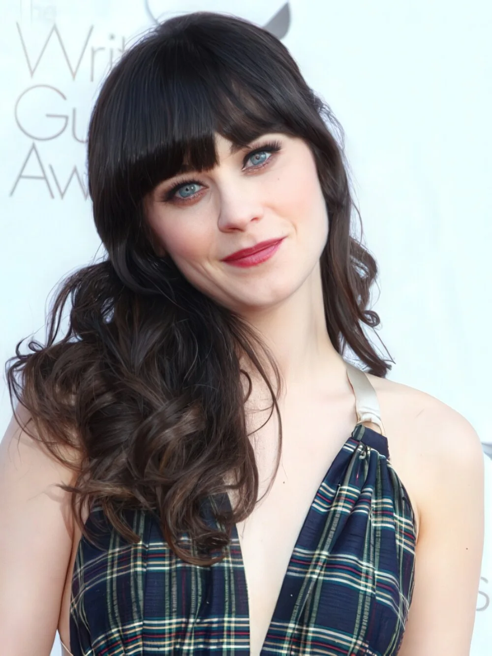Photo showing long dark curls with full fringe, with the hairstyle clearly visible.