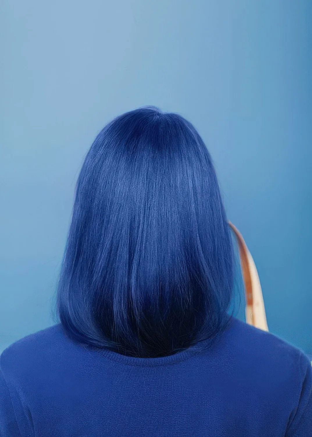 Photo showing blue to navy straight long bob, with the hairstyle clearly visible.
