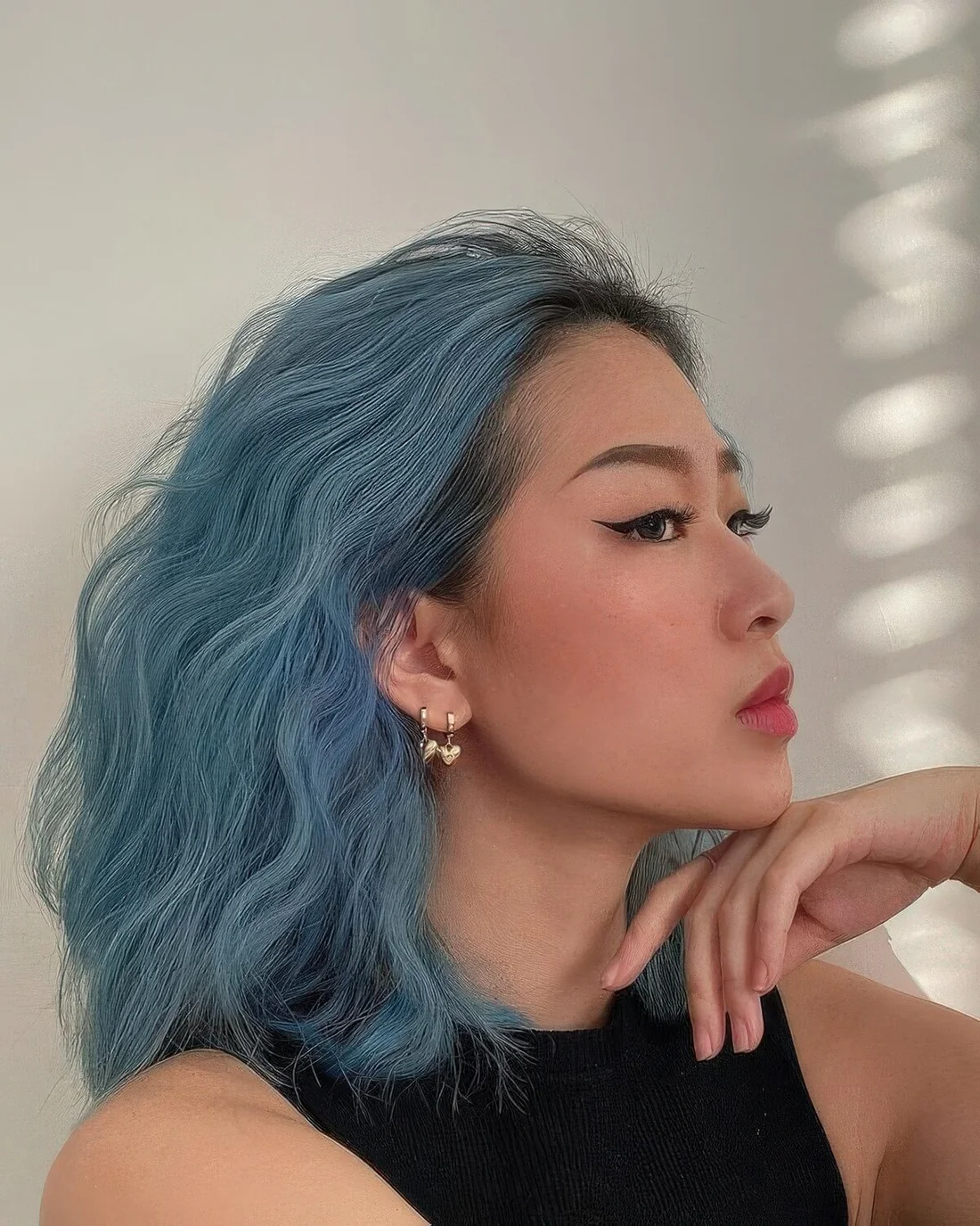 Ocean blue wavy long bob with a darker root.