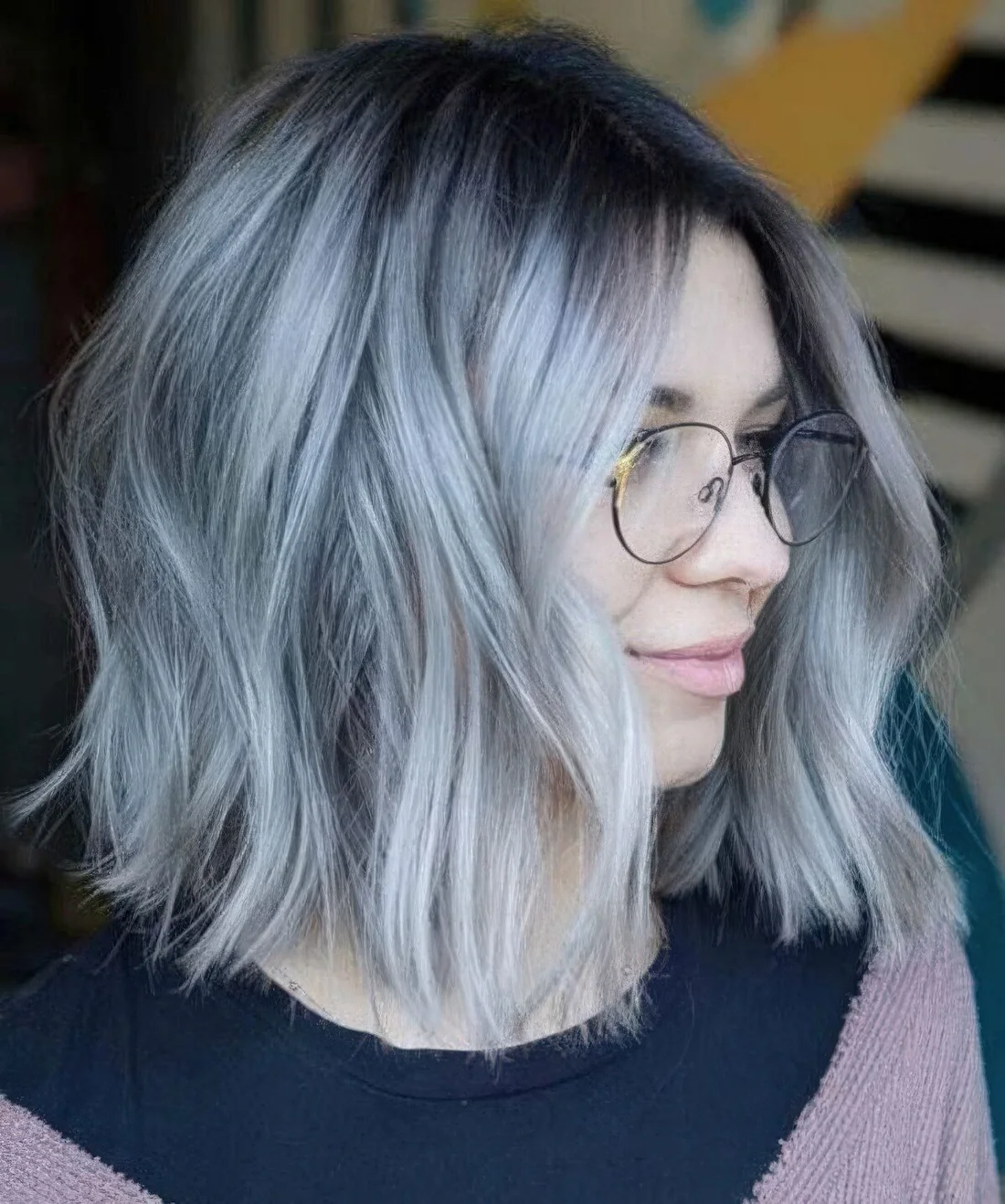 Pale blue choppy long bob with a darker root adn waves.