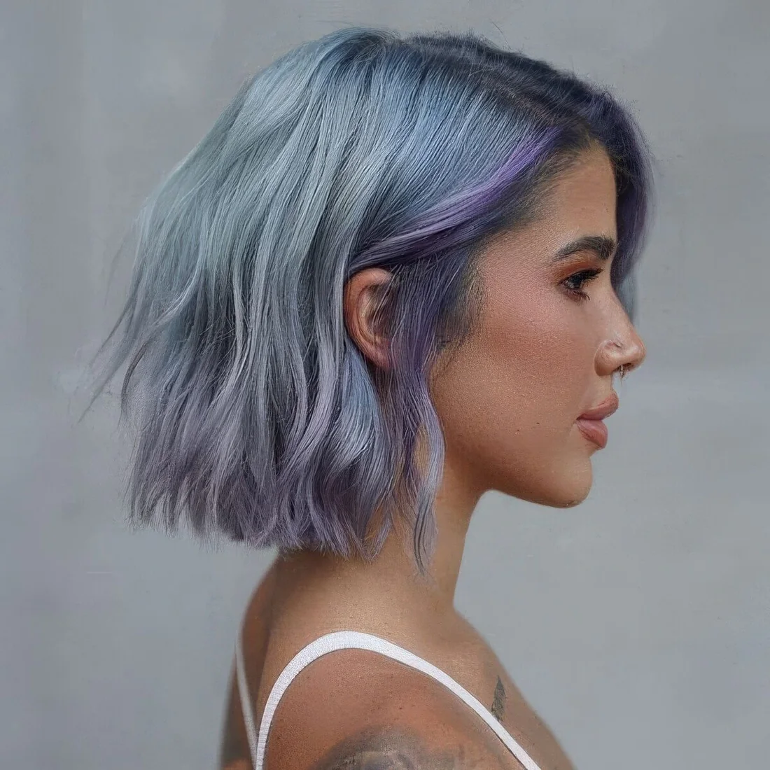 Pale blue choppy long bob with lilac locks and waves plus side part.