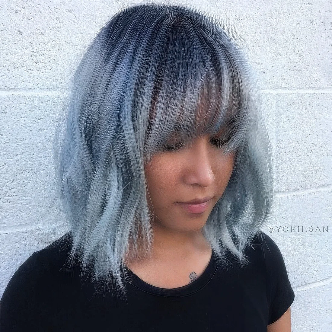 Pel blue layered long bob with wispy bangs and waves.