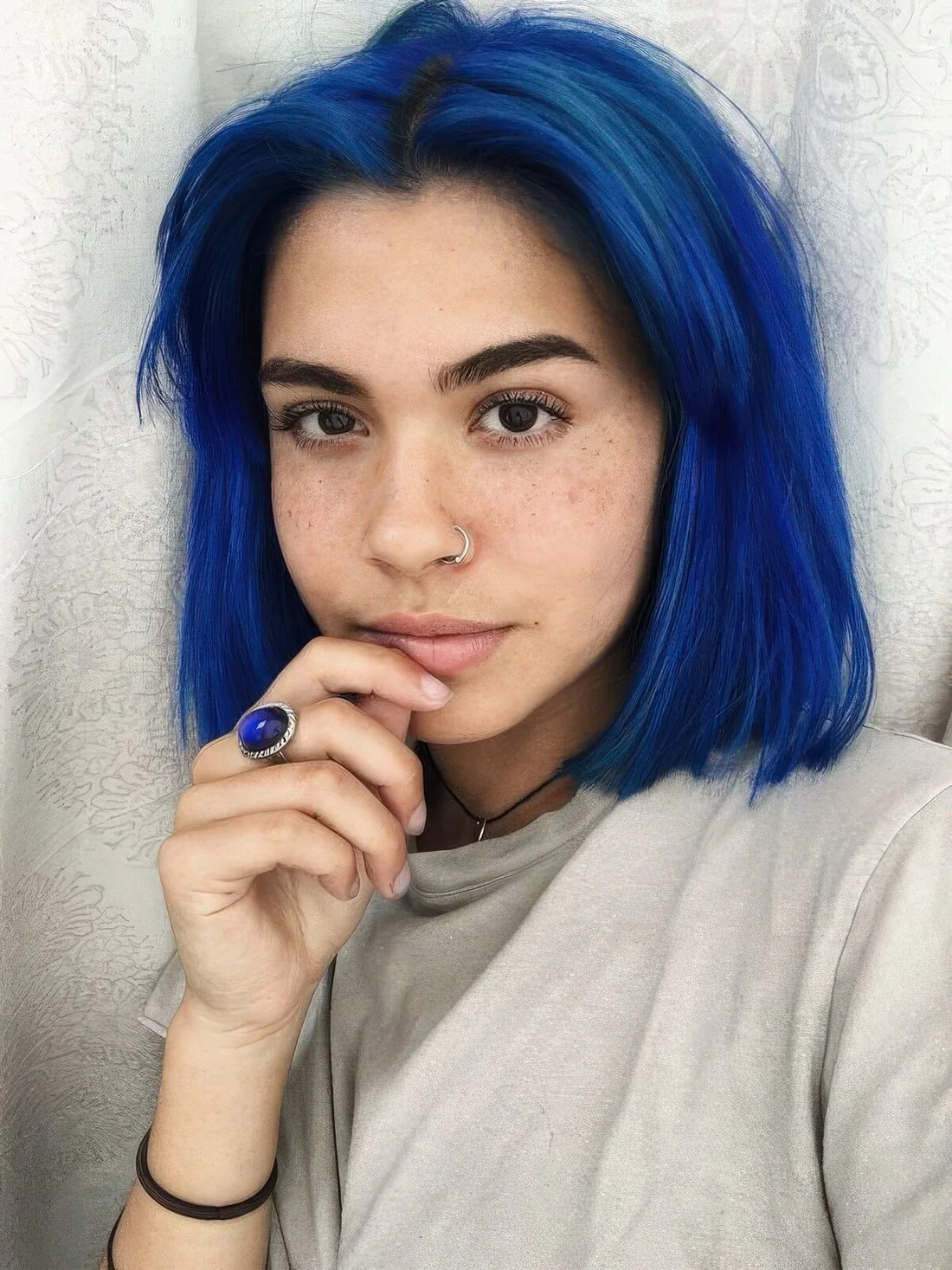 Blue bob with a darker root and curtain bangs plus volume.