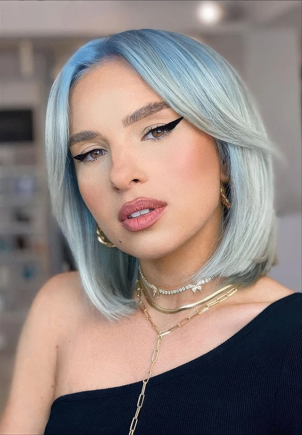 Aqua long bob with curtain bangs and center part.