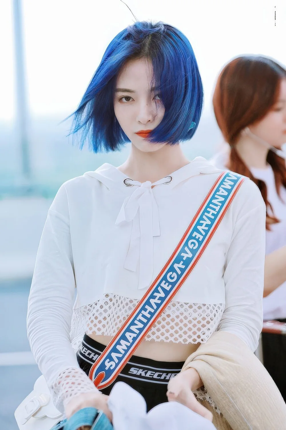 Electric blue chin-length bob with a black root.